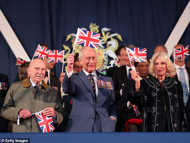 Charles and Camilla were both in high spirits as they held onto Union Jack flags this evening, at the concert