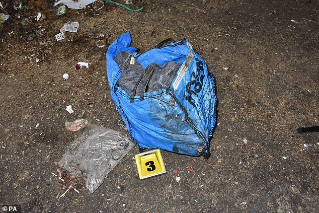 A large blue holdall recovered during a search at a refuse centre, containing bloodstained grey blankets, an unopened sparkling wine bottle, a selfie stick and LED colour changing lights
