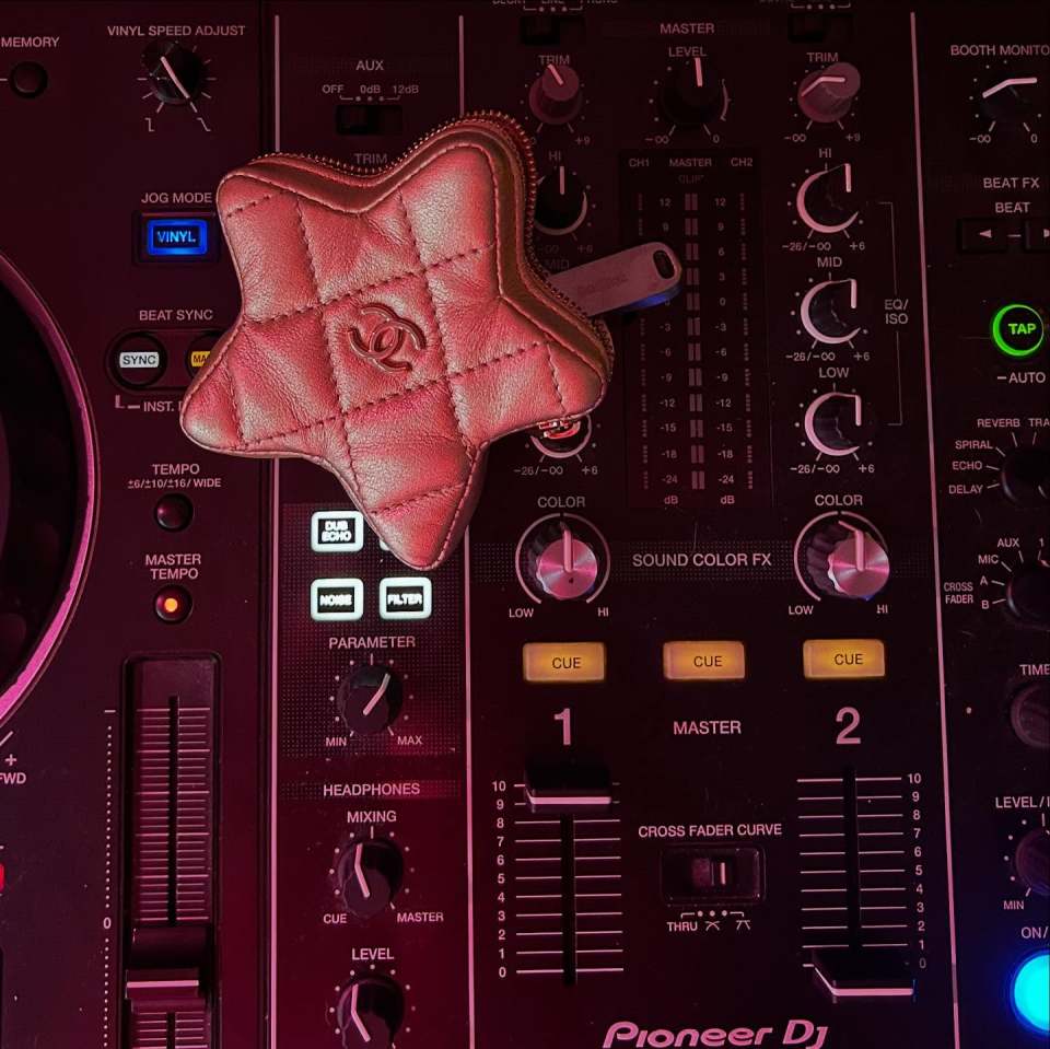 Star-shaped Chanel purse on a Pioneer DJ mixer.