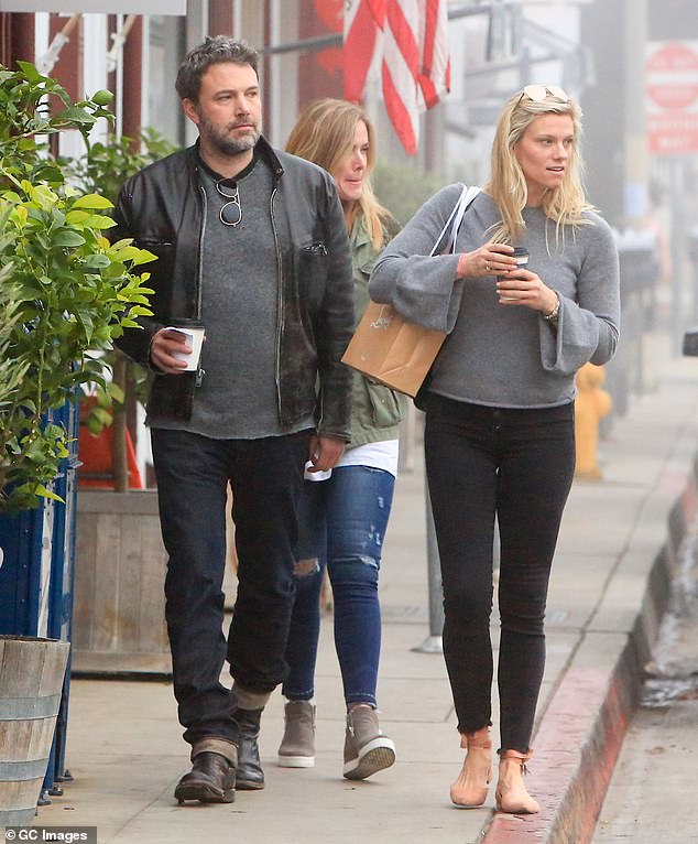After splitting from Garner but before their divorce was finalized, Affleck began a relationship with the Saturday Night Live producer Lindsay Shookus; pictured together in 2018 in LA