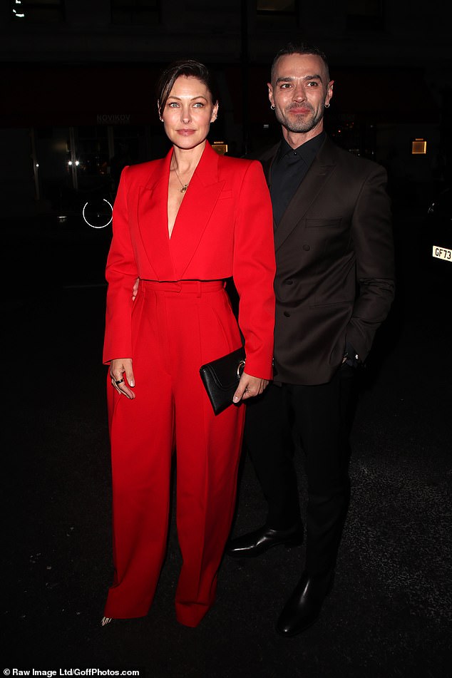 Emma Willis made sure to catch the eye in a bold red cropped blazer and matching tailored trousers as she arrived with husband Matt
