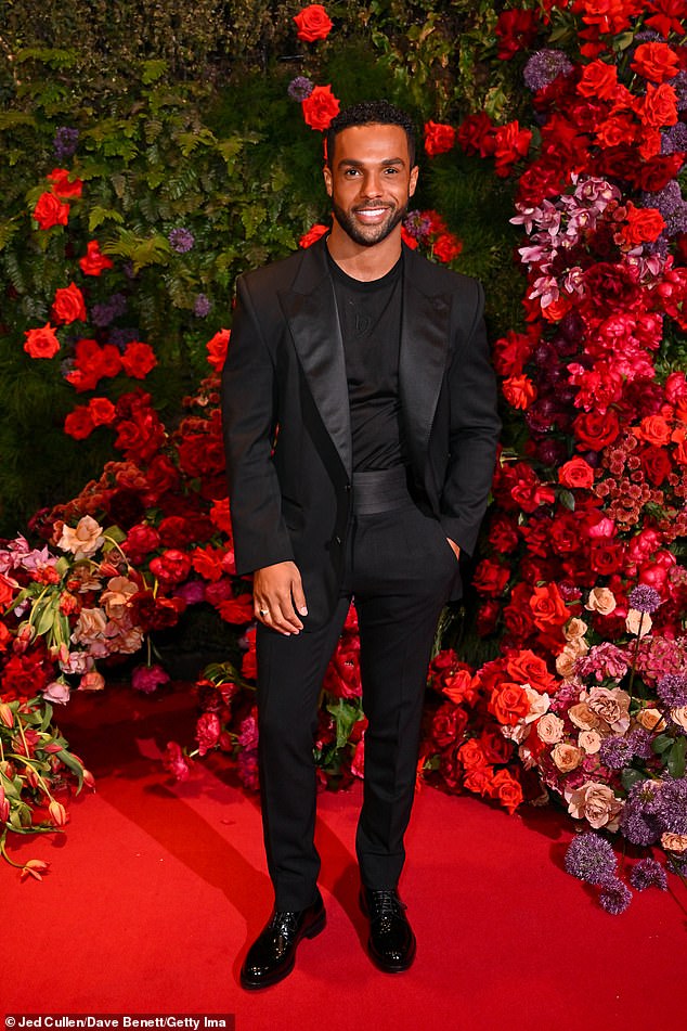 Emily In Paris hunk Lucien Laviscount caught the eye in a smart black blazer which he donned over a matching T-shirt and skinny trousers