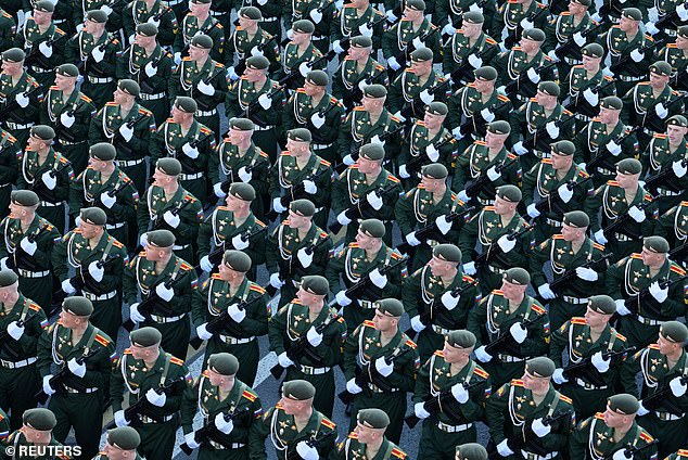 Russian service members march in columns before a military parade on Victory Day, marking the 80th anniversary of the victory over Nazi Germany in World War Two