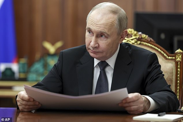 Russian President Vladimir Putin listens to Moscow Mayor Sergei Sobyanin during their meeting at the Kremlin in Moscow, Russia, Monday, May 5, 2025