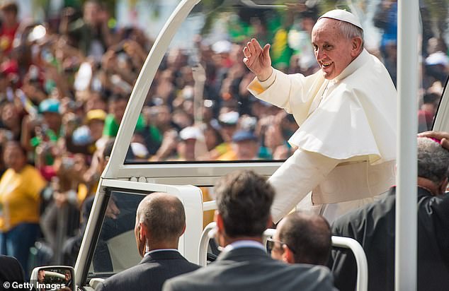 Pope Francis waves from the Popemobile as he arrives to celebrate Mass on Copacabana Beach in Rio de Janeiro, Brazil, during his first foreign trip since becoming pontiff, July 28, 2013