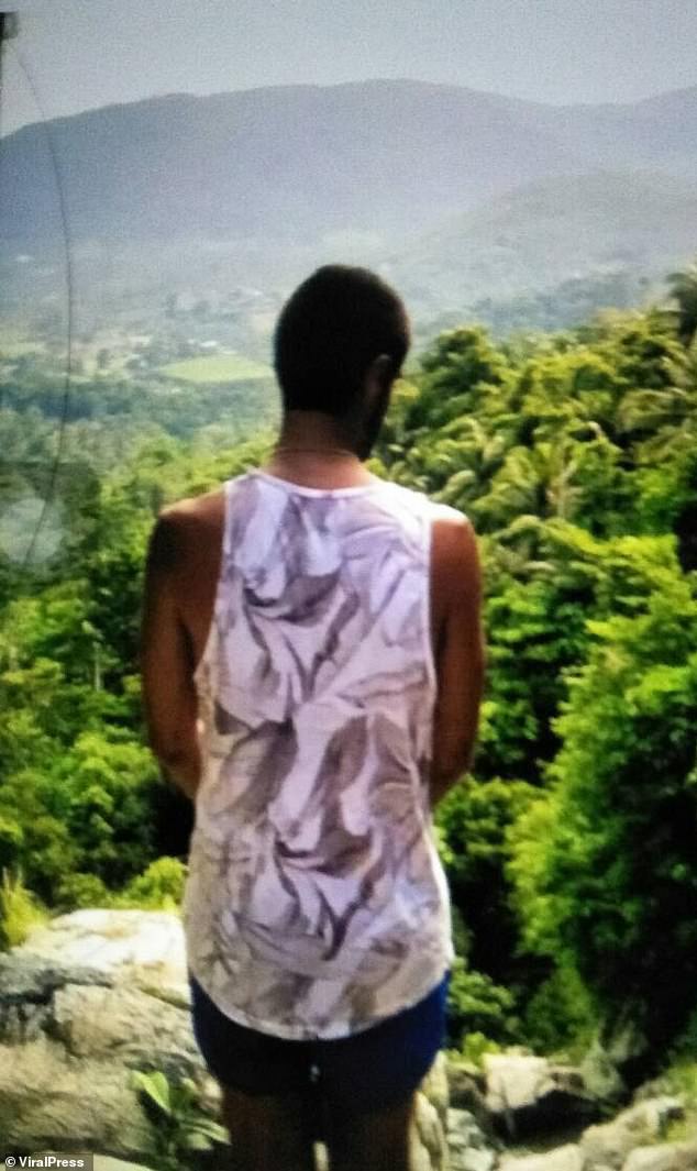 David, in blue shorts and white vest, posed looking down over the water as it splashed over the rocks