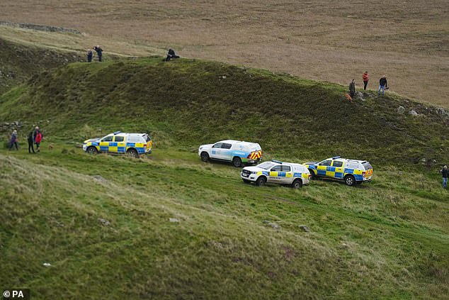 Police vehicles near the location of the tree next to Hadrian's Wall the day after it was cut down