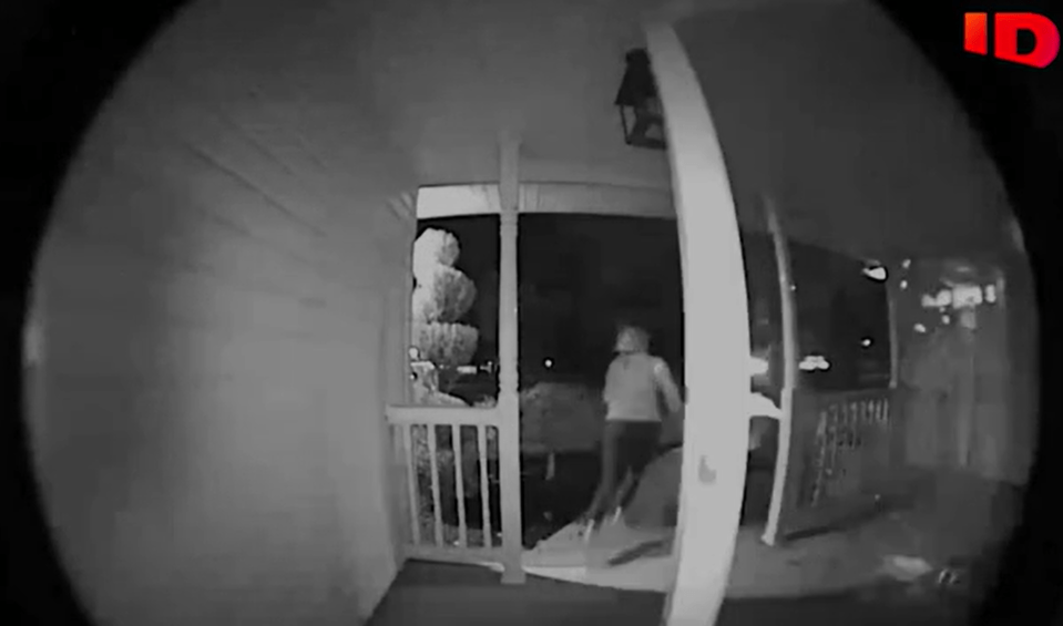 Night vision security camera footage of a person on a porch.