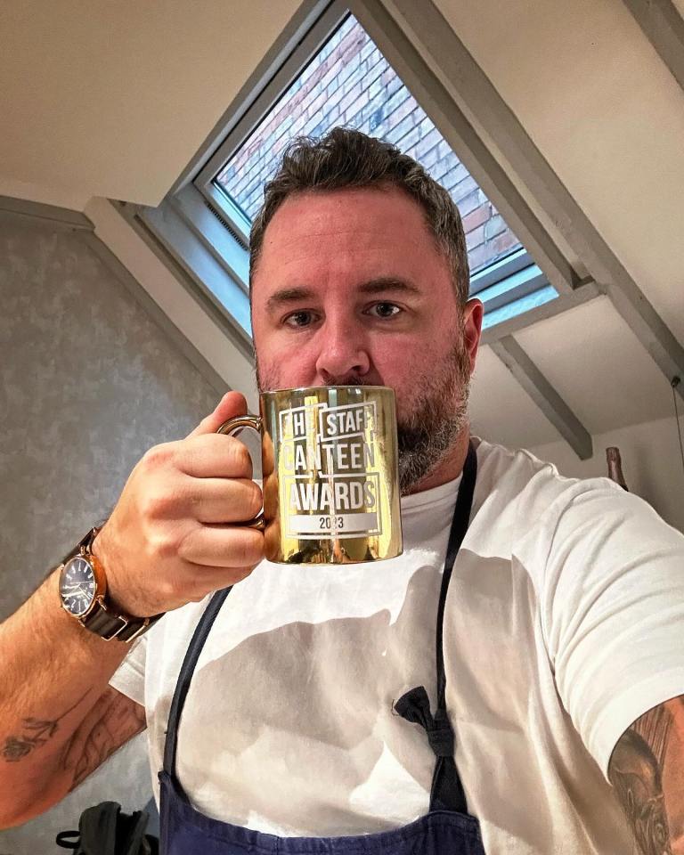 Chef Paul Foster holding a Staff Canteen Awards 2023 mug.