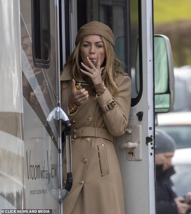 When she isn't posing up a storm for fashion campaigns Abbey Clancy, 38, is partial to a cigarette (pictured in February 2023)