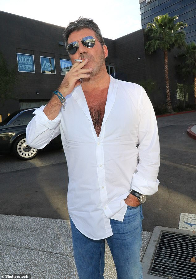 Simon Cowell has been attempting to quit smoking for years now and his son Eric has become the 'cigarette police' in his bid to stop his dad smoking (pictured in 2018)