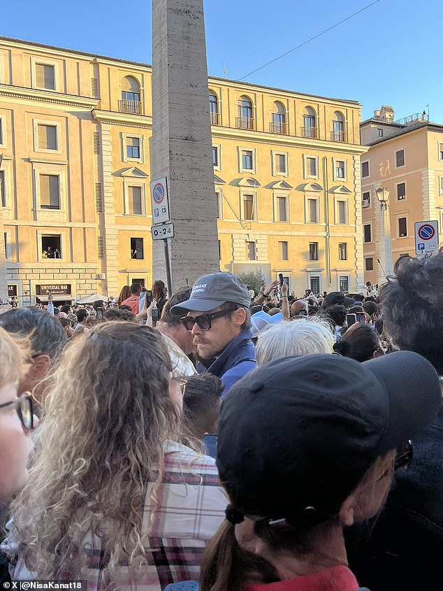 The singer, 30, kept a low-profile in a cap and sunglasses as he watched Pope Leo XIV deliver his first public remarks in his new position