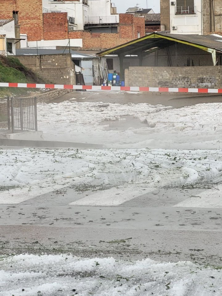 Hail covering a street and a parking lot after a hailstorm in Valencia, Spain.