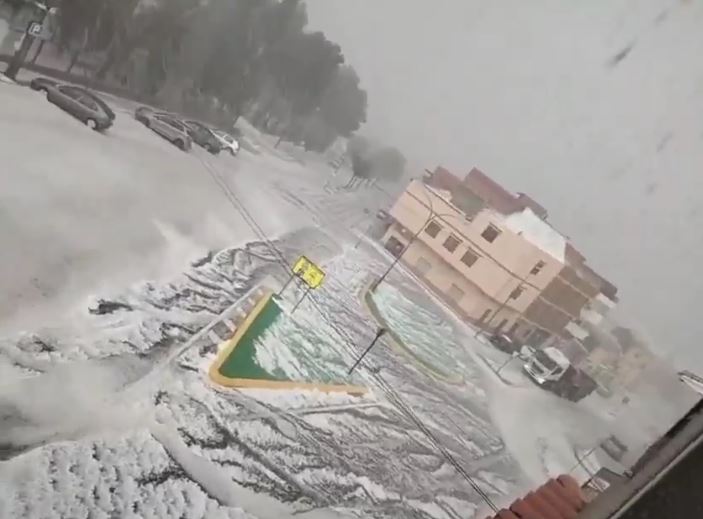 Street flooded with hail during a storm.