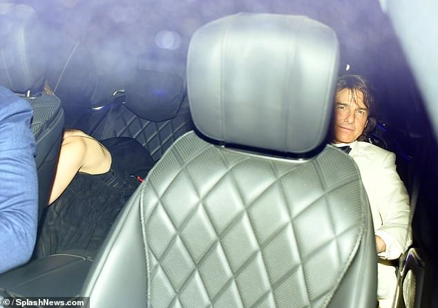 Ana and Tom tried their best to hide as they were spotted leaving David Beckham's 50th birthday party at Notting Hill's Core restaurant on Saturday night