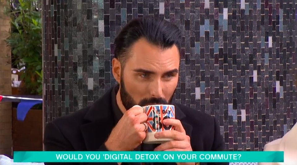 Rylan Clark drinking from a mug.