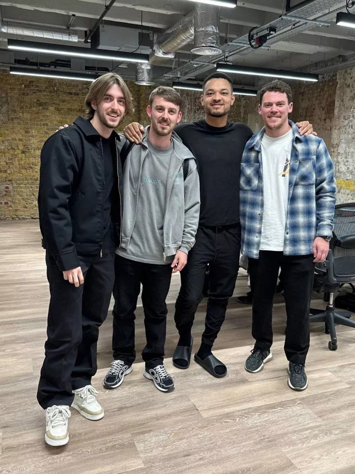 Four men posing for a photo.