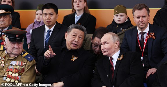 In this pool photograph distributed by the Russian state agency Sputnik, Russia's President Vladimir Putin and Chinese President Xi Jinping attend the Victory Day military parade at Red Square in central Moscow on May 9, 2025. Russia celebrates the 80th anniversary of the Soviet Union's victory over Nazi Germany in World War Two (WWII). (Photo by Vyacheslav PROKOFYEV / POOL / AFP) (Photo by VYACHESLAV PROKOFYEV/POOL/AFP via Getty Images)