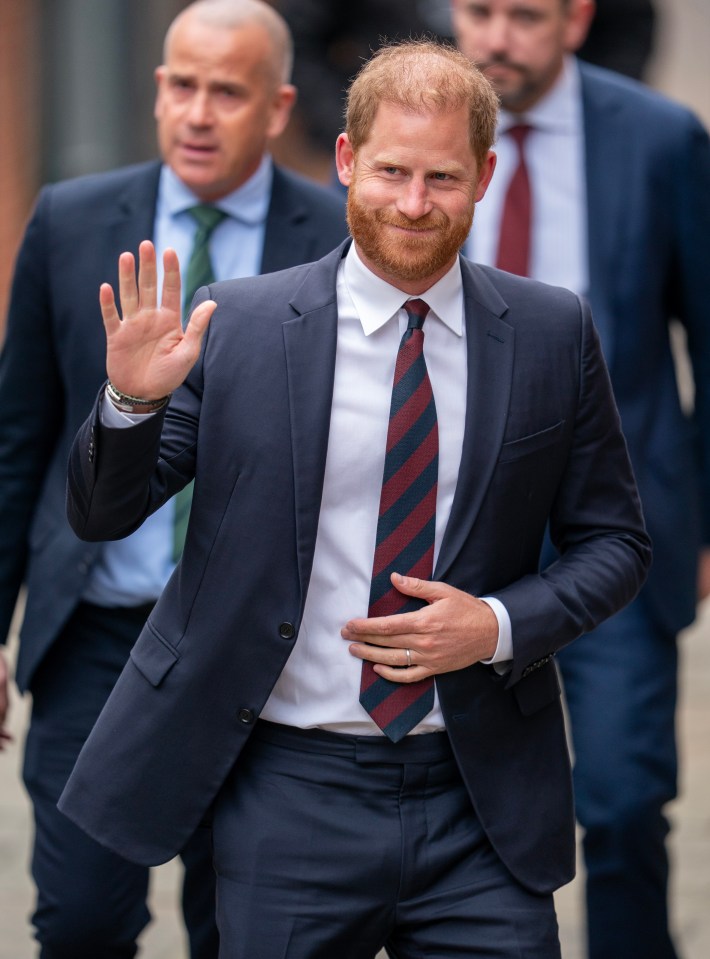 Prince Harry arriving at court, waving.