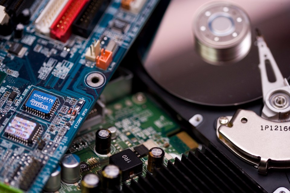 Close-up of computer circuit boards and hard drive components.