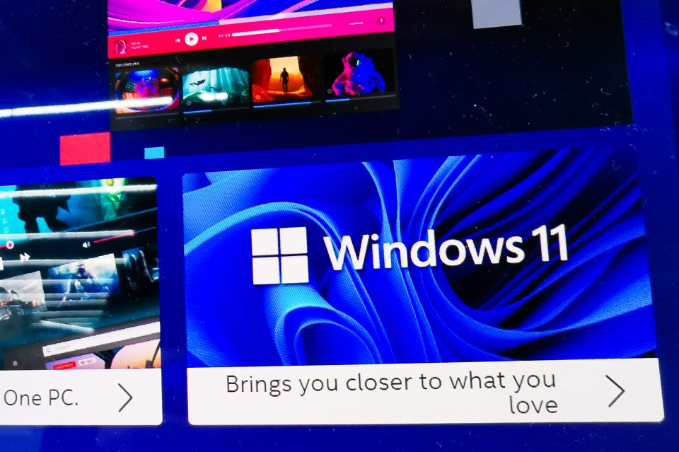 Windows 11 logo on a laptop screen.