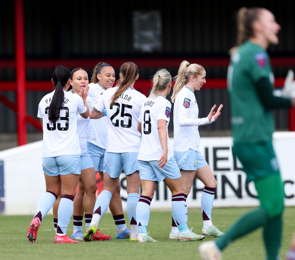 Aston Villa women's soccer team celebrating a goal.