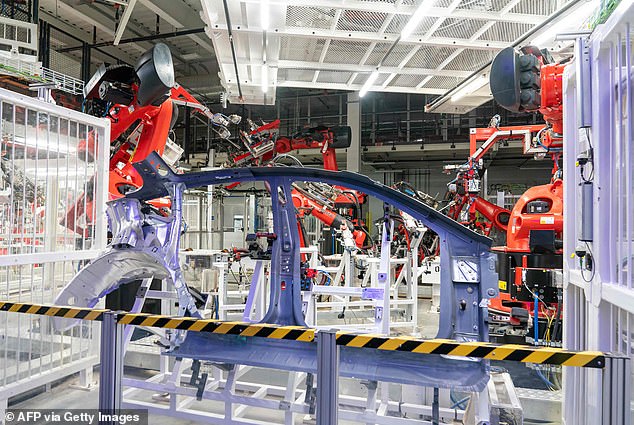 Two witnesses watched in horror as a fellow Tesla employee rescued the bloodied engineer from an unwitting, but violent robotic assault - perpetrated by an automated assembly device (like these red robot arms above) designed to grab and move freshly cast aluminum car parts
