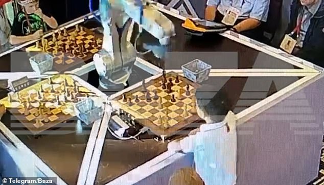 The robot appears to mistake the boy's finger for a chess piece, and grabs that instead, breaking his finger