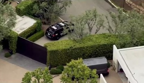 Aerial view of a police car at Jennifer Aniston's gate after a security incident.