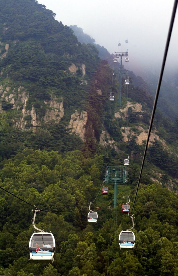 Cable cars ascending Tai Shan mountain in China.