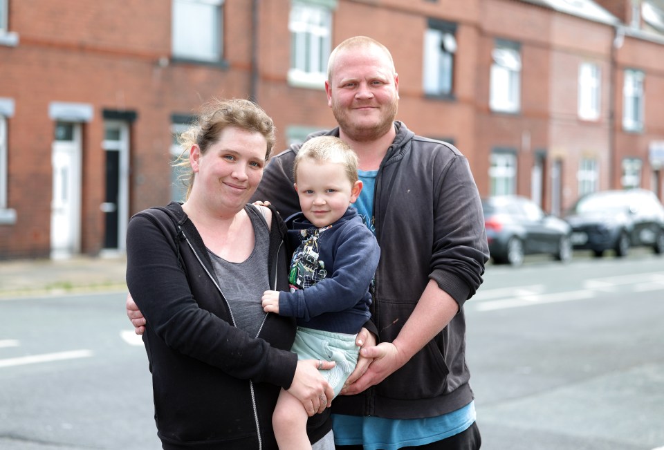 Family portrait in front of houses.