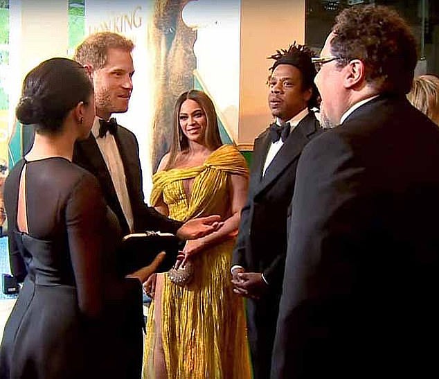Prince Harry and Meghan Markle crossed paths with Beyoncé and her husband Jay-Z at The Lion King premiere in 2019. During their meeting The Duke of Sussex (left) touted his wife's (far left) voiceover to The Lion King director Jon Favreau (right)