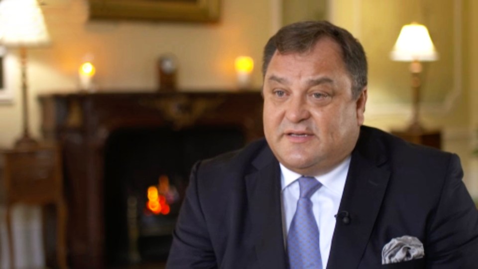 Robert Jobson in a suit, speaking.