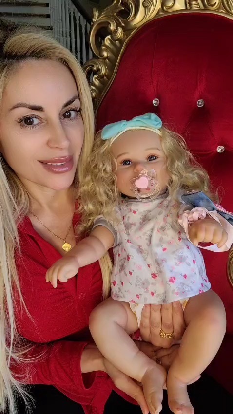 Woman holding a reborn doll.