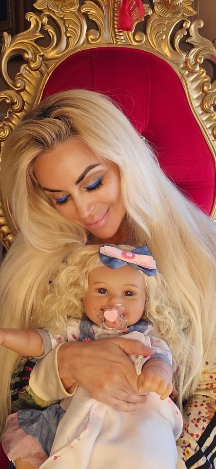 Woman holding a reborn doll.