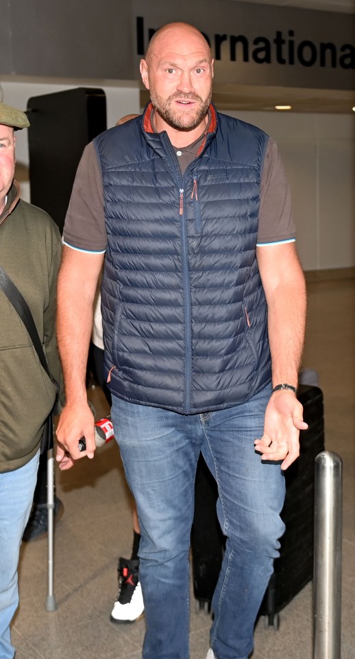 Tyson Fury arriving at an airport with his father.