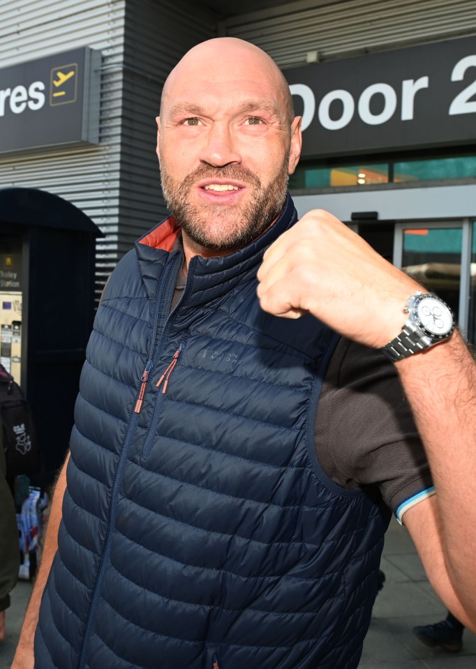Tyson Fury at an airport, making a fist.
