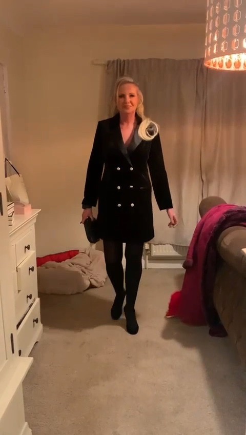 Woman in black velvet blazer dress.