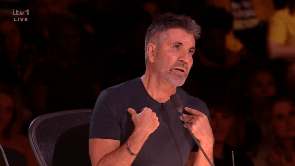 Simon Cowell speaking into a microphone.