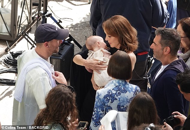 The baby drew admiring glances from the cast and crew of the hit Netflix show on set, including Philippine Leroy-Beaulieu (pictured), who plays Emily's boss Sylvie
