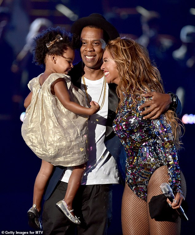 She’s also the youngest person in history to make the Billboard chart thanks to a cameo on dad’s 2012 single Glory on which she featured as baby. (Pictured: Jay Z and Beyoncé with daughter Blue Ivy Carter onstage during the 2014 MTV Video Music Awards).