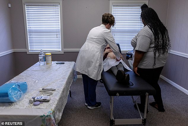 Doctors do an ultrasound on a pregnant woman during a pop-up health clinic in Alabama last year. The pop-up was sponsored by a state program, which receives federal funding