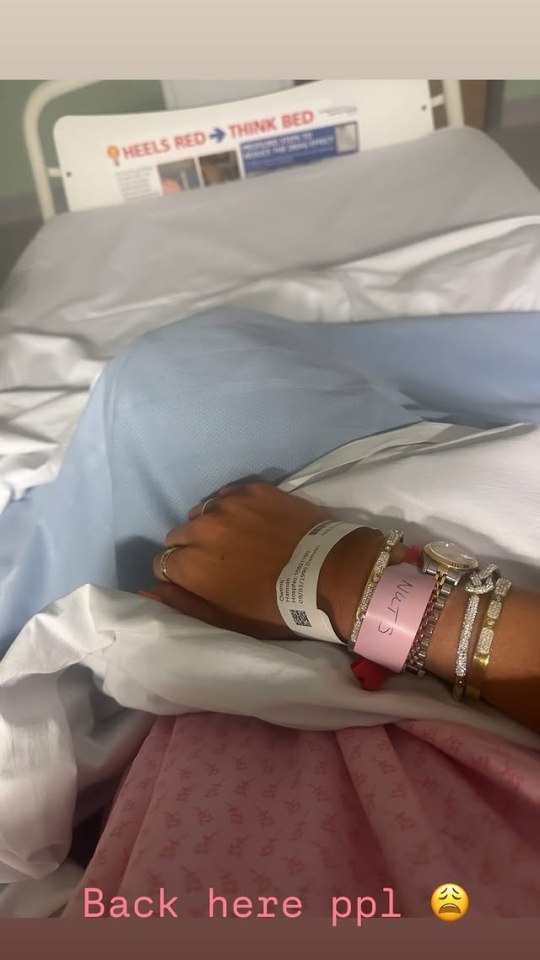 Woman's arm in hospital bed with hospital bracelet.