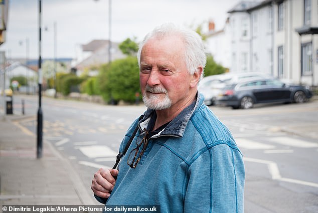 Pictured: Local resident Sam Hickman, 77, as he walked through the town