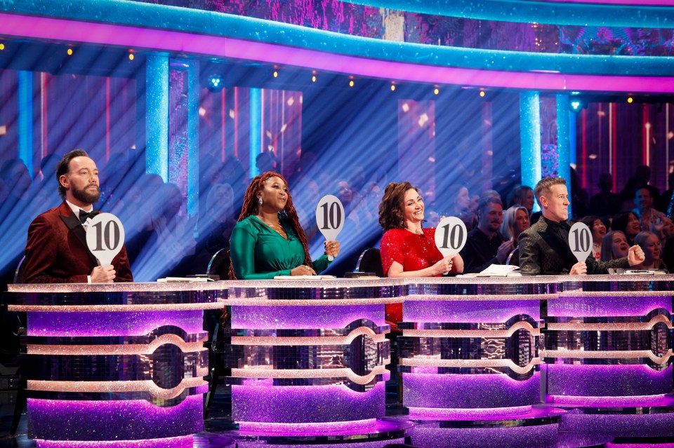 Strictly Come Dancing judges holding up score paddles showing a ten.