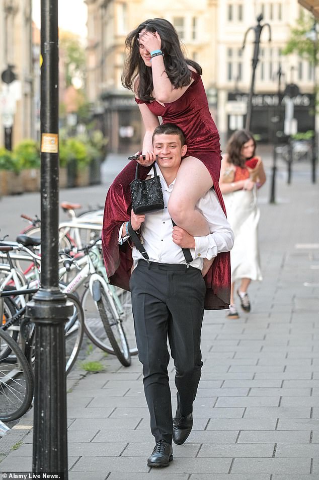 Others clutched their heels as they tried to give their tired feet a rest while one woman hitched a ride on a friend's shoulders