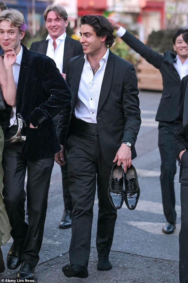 Pictured: A man walks barefoot on his way home from the Ball