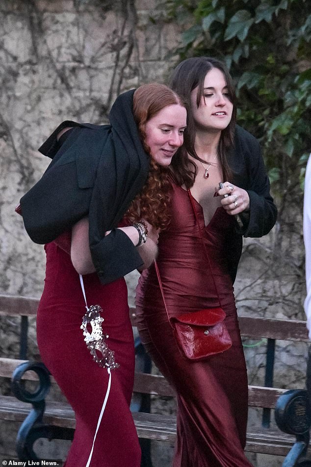 Pictured: Students share a jacket as they make their way home through the streets of Oxford