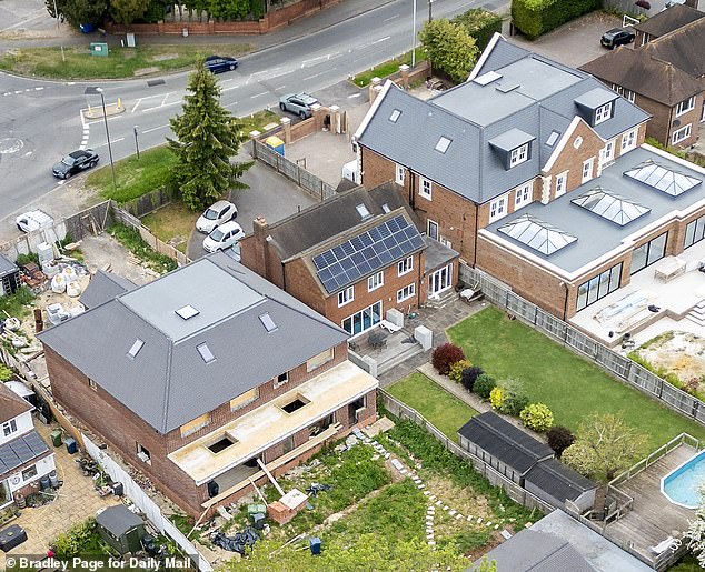 The row centres on an extension at the back of the house on Marlow Road which comes out further than what was approved in the original plans. Image shows the backs of the houses