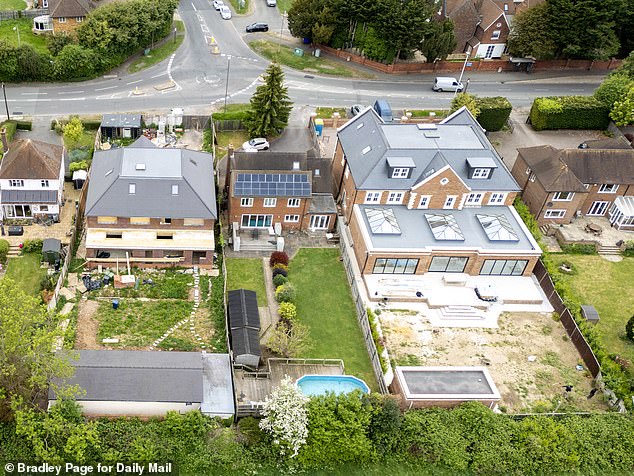 Documents show permission was last year granted for a six-bed home with three parking spaces to be built. (On the left: the house which was issued with an enforcement notice, on the right: the house that was given planning permission)